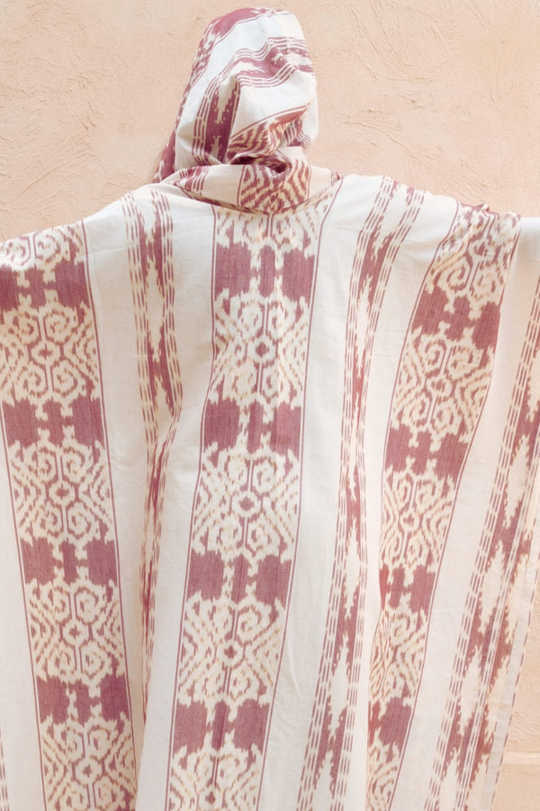 Mimpi Hooded Poncho Cape — Women's Burgundy White, close detail of the hand-dyed Ikat weave