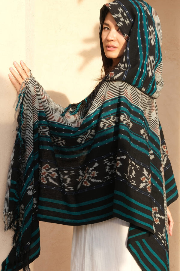 Mimpi Hooded Poncho Cape — Women's Grey Teal, close detail of the hand-dyed Ikat weave